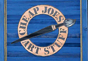a painted blue wooden board with Cheap Joes Art Stuff in a tan circle and a stylized paint brush through the circle