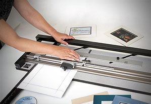 person using Logan 650 Mat Cutter